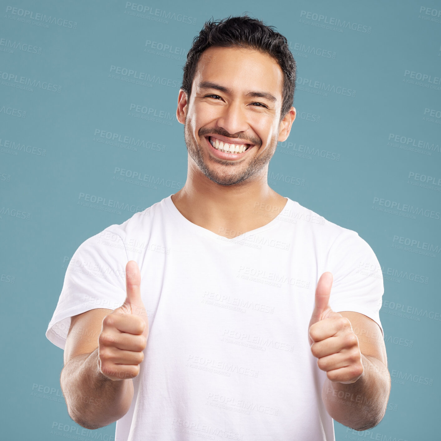 Buy stock photo Portrait, smile and man with thumbs up in studio for yes, thank you sign and feedback on news. Happy, male person and hand gesture for agreement, like opportunity and vote approval on blue background