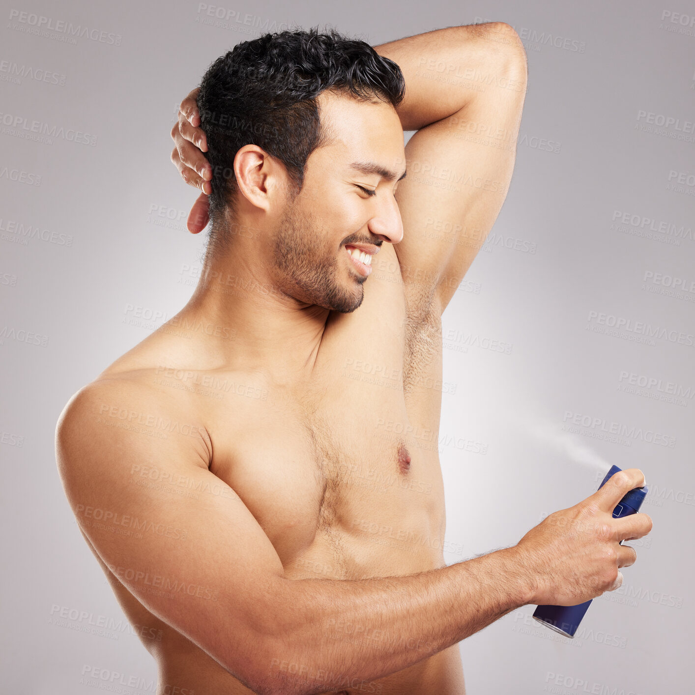 Buy stock photo Studio, man and spray with deodorant for armpit, hygiene and wellness with smile for cosmetics. Happiness, male person and model with skincare for sweat control, perfume product and gray background