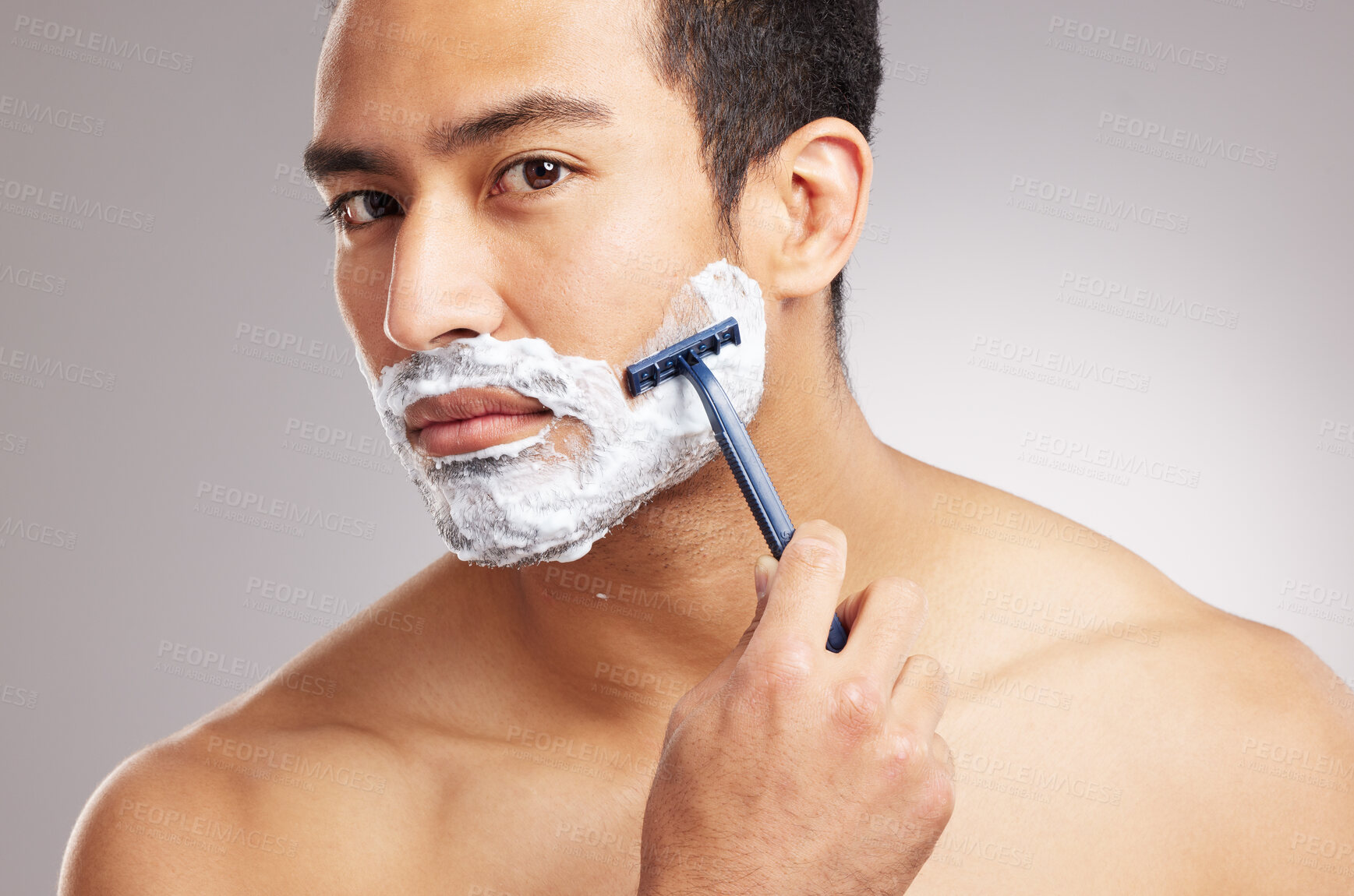 Buy stock photo Man, portrait and hair removal with razor in studio, grooming and wellness with model for self care. Male person, cosmetics and foam with tool to shave beard, hygiene and skincare by white background