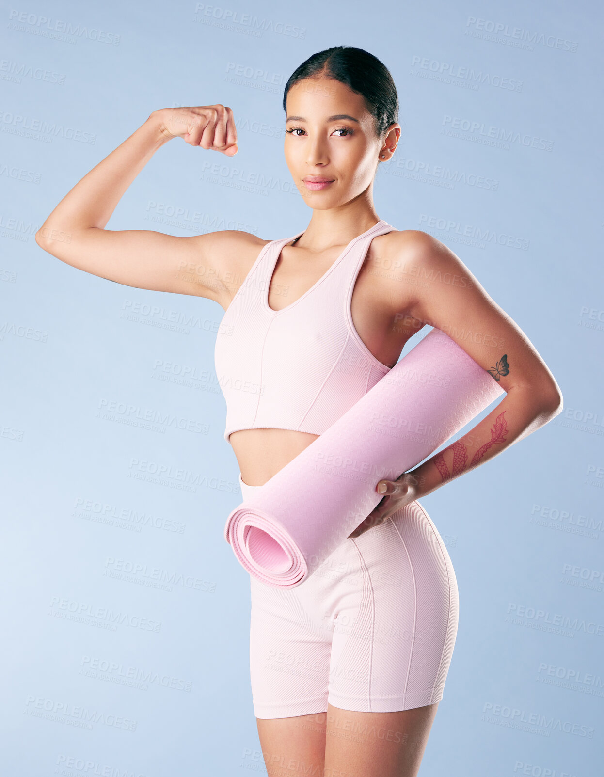 Buy stock photo Strong portrait, yoga and woman with fitness in studio for pilates exercise, biceps progress or workout results. Girl, confidence and arm flex with mat for healthy body or wellness on blue background