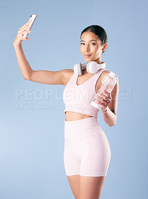 Buy stock photo Studio, woman and portrait with selfie for fitness, wellness or profile picture for social media. Mockup, female person and model with photography for exercise memory, water bottle or blue background