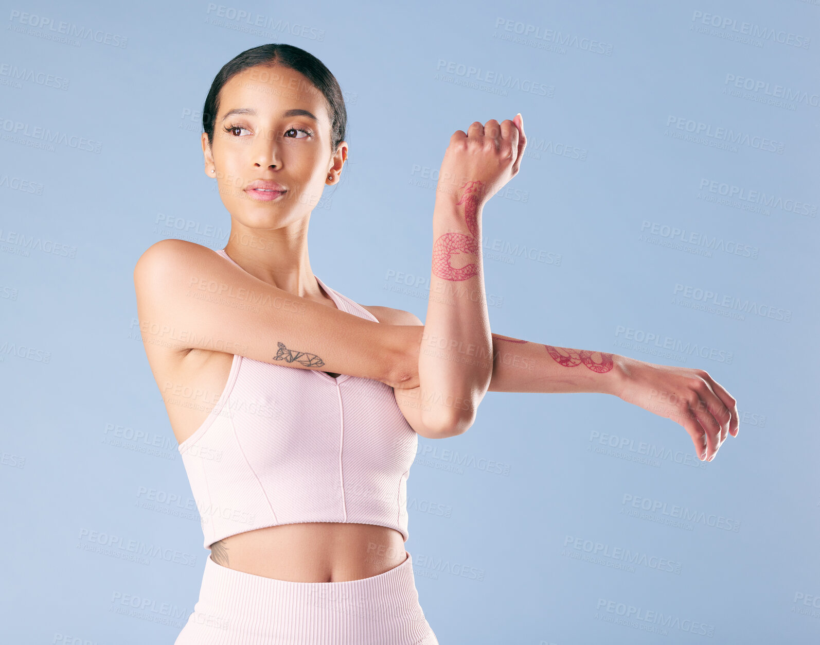 Buy stock photo Woman, arms and stretching in studio for fitness, prevent muscle injury and thinking for workout. Model, female person and wellness with confidence for exercise idea, warm up or blue background space