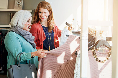 Buy stock photo Woman, daughter and shopping for clothing with choice, decision and retail fashion sale for luxury wardrobe at boutique. Smile, mature mother and customer, designer product for quality fabric at shop