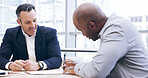 Businessmen, writing or negotiation with signature for legal agreement, contract or policy at office. Business people, employee or coworker with paperwork for corporate assets, partnership or deal