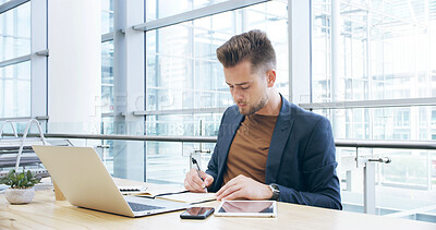 Buy stock photo Laptop, planning and writing with business man at desk in office for online report or research. Computer, notebook and schedule with professional employee in agency workplace for information review