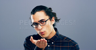 Buy stock photo Blowing, kiss and portrait of man in studio with reaction for flirting, romance and pride. Mockup space, hand gesture and person with emoji for love, dating and valentines day on gray background