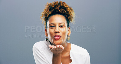 Buy stock photo Woman, portrait and blowing kiss in studio for affection, romance and flirting on gray background. Mockup space, person and kindness gesture for gratitude, thank you and attraction with smile or care