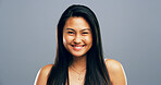 Happy, asian woman and portrait with hair style or positive attitude for creative ambition on a gray studio background. Face, female person or gen z model with smile or confidence for natural beauty