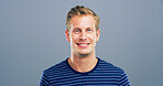 Happy man, portrait and fashion with positive attitude for casual style or confidence on a gray studio background. Face, male person or model with smile in stylish striped tshirt or outfit on space