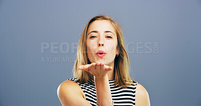 Buy stock photo Blowing kiss, love and portrait of woman with reaction for flirting, romance and confident on blue background. Happy, hand gesture and isolated person with emoji for care, dating and mockup space