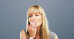 Woman, portrait and blowing with kiss in studio for affection, love or romance on a gray studio background. Female person, face or blonde model with romantic gesture for distant compassion on space