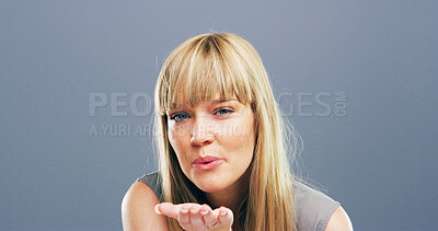 Buy stock photo Blowing kiss, studio and portrait of happy woman with reaction for flirting, romance and affection. Confident, hand gesture and person with emoji for love, dating and mockup space on blue background