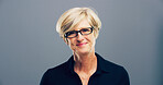Mature, portrait and happy woman with glass in studio for creative development on a gray background. Face, female person or designer with smile, frame or lens for sight or optometry on mockup space