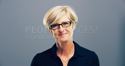 Buy stock photo Mature, portrait and happy woman with glasses in studio for creative development on a gray background. Face, female person or designer with smile, frame or lens for sight or optometry on mockup space