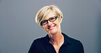 Mature, portrait and happy woman with glasses for sight or creative pride on a gray background. Face, female person or designer with smile, frame or lens for optometry care or health on mockup space