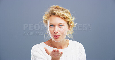 Buy stock photo Blowing kiss, happy and portrait of woman for flirting, romance and confident on blue background. Playful, hand gesture and isolated person with emoji for love, dating and mockup space in studio
