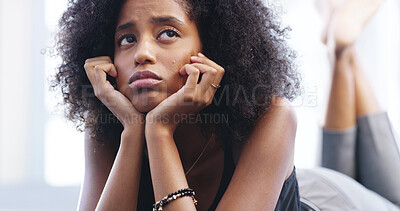 Buy stock photo Depression, sad and thinking with woman in bedroom of home for breakup or unhappy memory. Anxiety, burnout and mental health with miserable, moody or thoughtful African person on bed in apartment