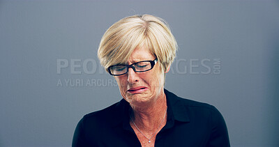 Buy stock photo Sad, woman and crying tears in studio with depression, mourning loss and emotional memory. Mature person, grief and mockup with mental health crisis, bad news and ptsd challenge on gray background