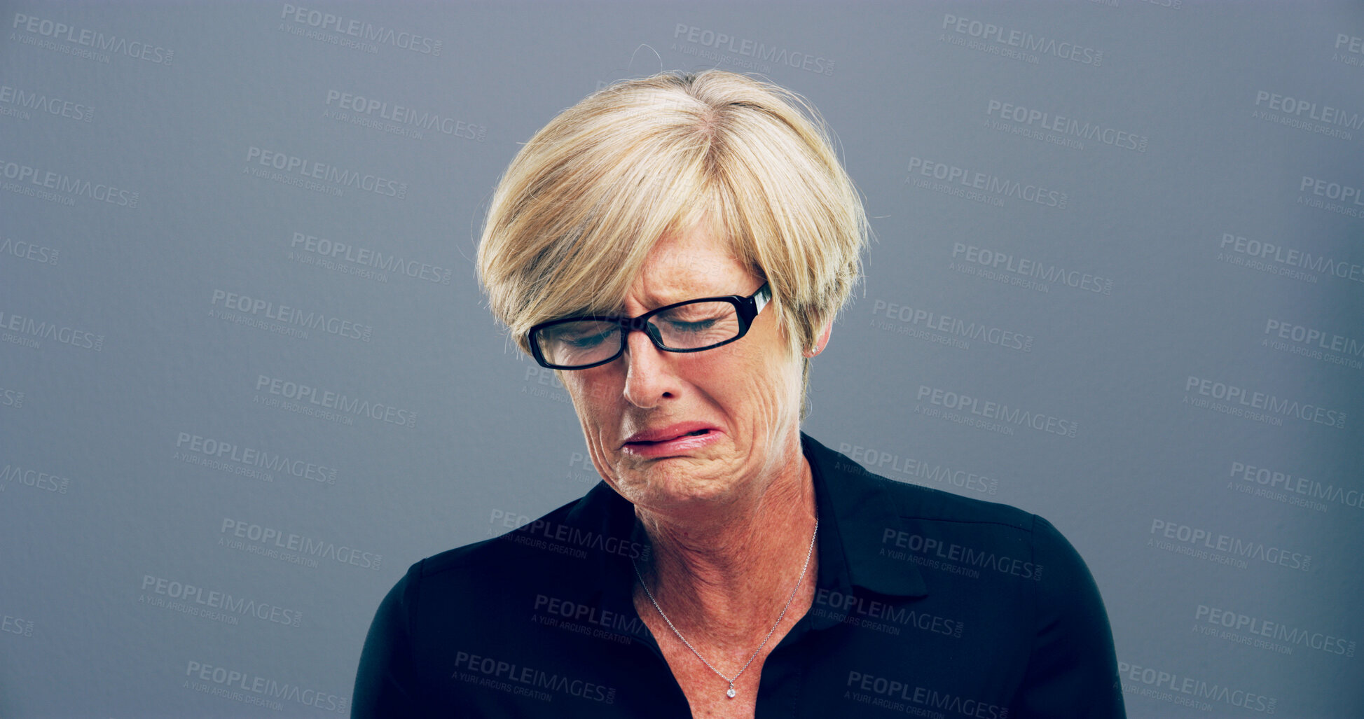 Buy stock photo Sad, woman and crying tears in studio with depression, mourning loss and emotional memory. Mature person, grief and mockup with mental health crisis, bad news and ptsd challenge on gray background