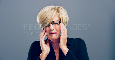 Buy stock photo Lonely, mature woman and crying in studio for depression, mourning loss and emotional memory. Female person, grief and mockup for mental health crisis, bad news and ptsd heartbreak on gray background