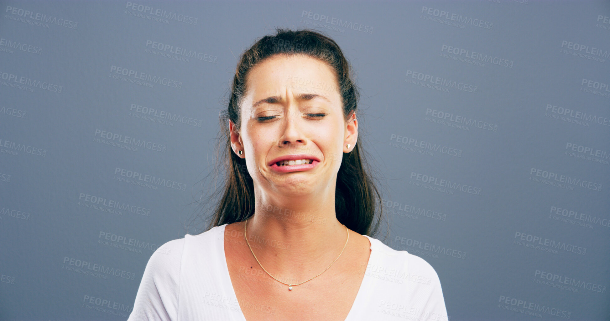Buy stock photo Depression, crying and anxiety with woman in studio for mental health crisis, trauma or broken heart. Unhappy face, sad or female person with bad news, stress or abuse victim on gray background space