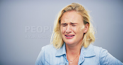 Buy stock photo Sad, crying and woman with depression in studio, mental health crisis or broken heart with trauma. Unhappy face, anxiety and female person with stress, frustrated or bad news on gray background space