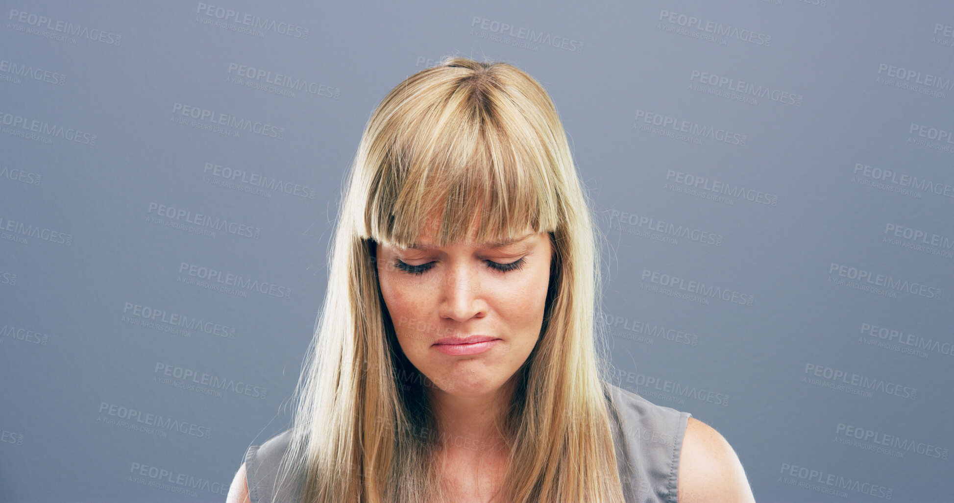 Buy stock photo Emotional, crying and woman with depression, studio and sad for loss of relationship, divorce and grief. Mockup space, blue background and person with heartbreak for breakup, disappointed and lonely