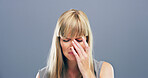 Sad, crying and woman with stress in studio, mental health crisis or broken heart with trauma. Unhappy face, depression and female person with anxiety, abuse and bad news on gray background space