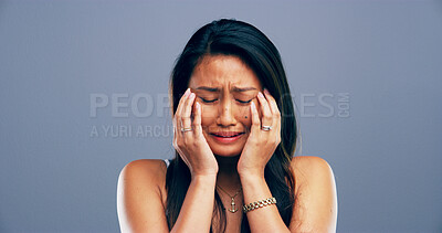 Buy stock photo Pain, crying and woman with depression, tears and emotional for loss of relationship, trauma and studio. Mockup space, blue background and person with heartbreak for breakup, disappointed and sad