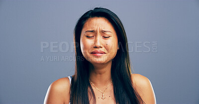 Buy stock photo Mental health, crying and woman with depression, studio or emotional for loss of relationship, pain and tears. Mockup space, blue background or person with heartbreak for breakup, disappointed or sad