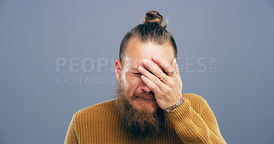 Buy stock photo Crying, sad and man with hand in studio with depression, heartbreak and emotional on blue background space. Tears, mourning and person with grief, upset and unhappy for breakup, bad news and pain