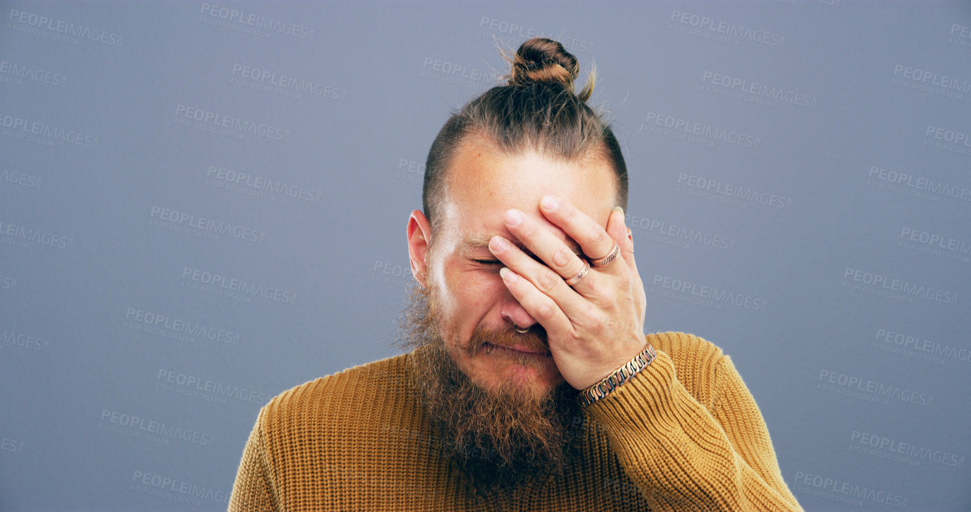 Buy stock photo Crying, sad and man with hand in studio with depression, heartbreak and emotional on blue background space. Tears, mourning and person with grief, upset and unhappy for breakup, bad news and pain
