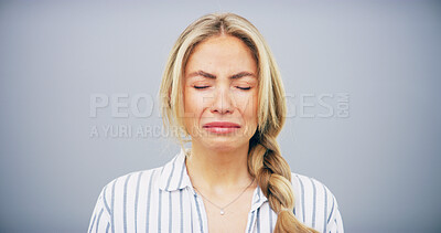 Buy stock photo Crying, sad and face of woman in studio with depression, heartbreak and emotional on blue background. Tears, mourning and isolated person with grief, upset and unhappy for breakup, bad news and pain