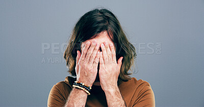 Buy stock photo Sad, crying and man with depression in studio for mourning loss, emotional memory and regret. Grief, person and cover face with space for mental health, bad news and ptsd trauma on gray background