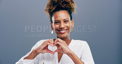 Buy stock photo Happy, portrait and girl with heart hands in studio for appreciation, support and kindness. Mockup space, person and love gesture on gray background for care, gratitude and motivation sign with pride
