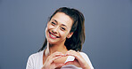 Heart, studio and portrait of woman with smile and gesture for support, kindness and care. Happy, confident and person with emoji, sign and hope for thank you, charity and love on blue background