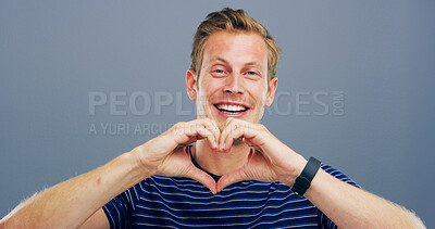 Buy stock photo Heart hands, studio and portrait of man with gesture for support, kindness and care. Happy, confident and person with emoji, sign and hope for thank you, charity and love on blue background