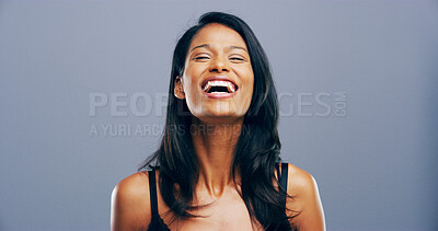 Buy stock photo Studio, woman and laughing in portrait for joke, funny memory and comedy with mockup space. Model, female person and happiness with humor by blue background, satisfaction and expression of emoji