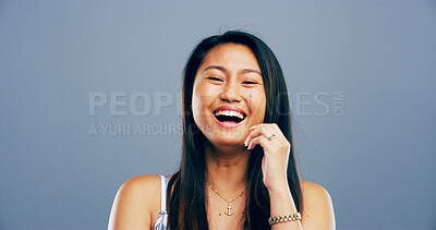 Buy stock photo Asian woman, portrait and laughing in studio for joke, funny memory and comedy with mockup space. Model, female person and happiness with humor by blue background, satisfaction and emoji reaction