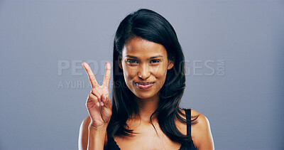 Buy stock photo Woman, peace sign and smile in studio for cosmetics, beauty or symbol with results by background. Girl, person and happy for emoji, portrait or natural makeup for change with hand gesture in Colombia