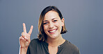 Woman, peace sign and excited in studio portrait with smile, icon and v symbol for victory by background. Girl, person and happy winner with emoji, fashion and review with hand gesture in England
