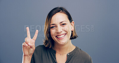 Buy stock photo Woman, peace sign and excited in studio portrait with smile, icon and v symbol for victory by background. Girl, person and happy winner with emoji, fashion and review with hand gesture in England