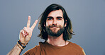 Man, peace sign and happy in studio portrait, icon and v symbol for victory by background. Model, person and excited with beard, smile and emoji with fashion, vote and hand gesture in Argentina