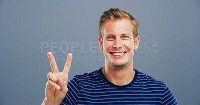 Buy stock photo Man, peace sign and excited in studio portrait, icon and v symbol with confidence by background. Model, person and happy with space, smile and emoji with fashion, vote and hand gesture in Germany