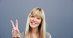 Girl, peace sign and happy with space in studio portrait, icon and v symbol for victory by background. Woman, person and smile with emoji, fashion and review with style with hand gesture in Germany