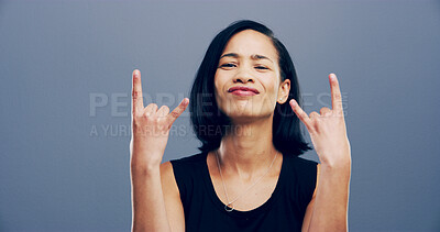 Buy stock photo Rocker, hand and attitude with portrait of woman in studio for metal music, punk identity or crazy. Devil horn sign, edgy or funky with person on gray background space for energy, emoji or expression