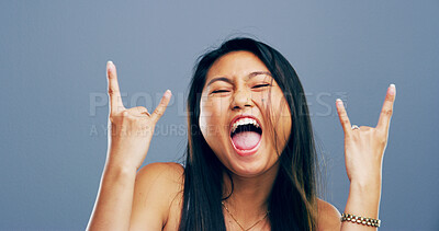 Buy stock photo Rocker, hand and energy with portrait of Asian woman in studio for metal music, punk identity and crazy. Devil horn sign, edgy and attitude with person on background for funky, emoji and expression