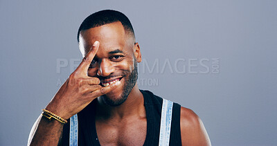 Buy stock photo Rocker, hand and smile with portrait of black man in studio for metal music, punk identity and crazy. Devil horn sign, edgy or attitude with person on background space for energy, emoji or expression
