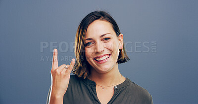Buy stock photo Devil horn, hand and portrait of woman in studio for metal music, punk identity and smile. Rocker sign, edgy and attitude with happy person on background for girl, emoji and funky expression