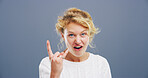 Rocker, hand and cool with portrait of woman in studio for metal music, punk identity and crazy. Devil horn sign, edgy and attitude with person on background for energy, emoji and expression